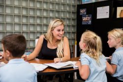 Teacher laughing with students